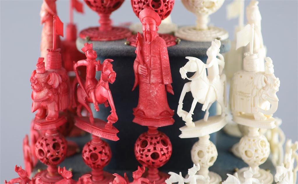 A set of 19th century Cantonese carved and red stained ivory chess pieces under dome, white king 20cm high